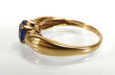 Lot An 18ct yellow gold ring set pale oval...