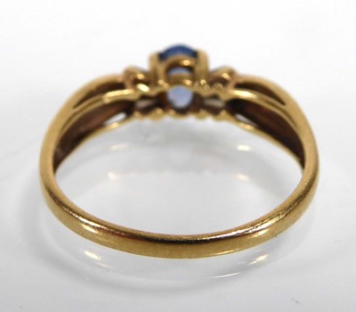 Lot An 18ct yellow gold ring set pale oval...