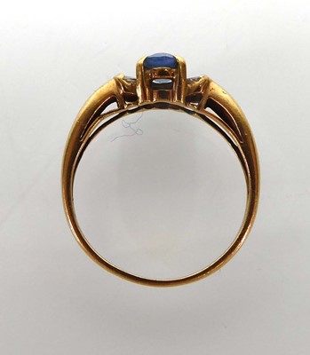 Lot An 18ct yellow gold ring set pale oval...