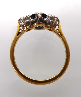 Lot An 18ct yellow gold ring set oval dark...