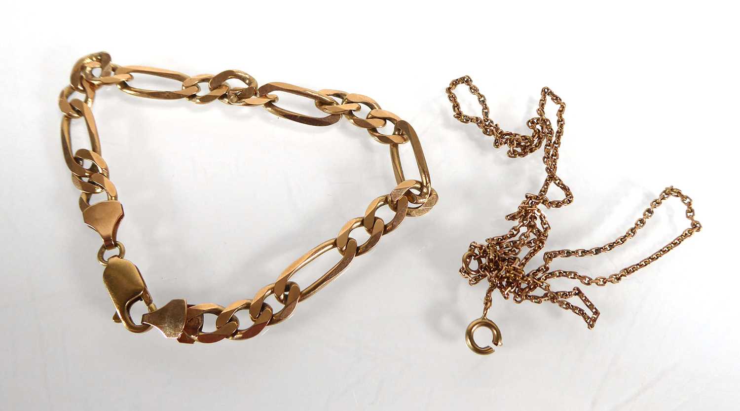 Lot A 9ct yellow gold figaro link bracelet with...