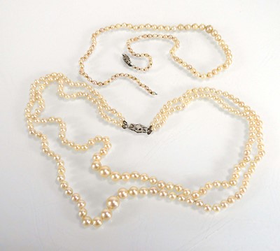 Lot A double strand cultured pearl necklace with...