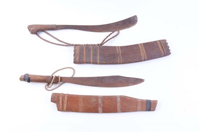 Lot 70 - Two Eastern machetes, each in wooden scabbard