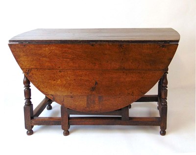 Lot 15 - A Geo III oak drop leaf dining table, with...