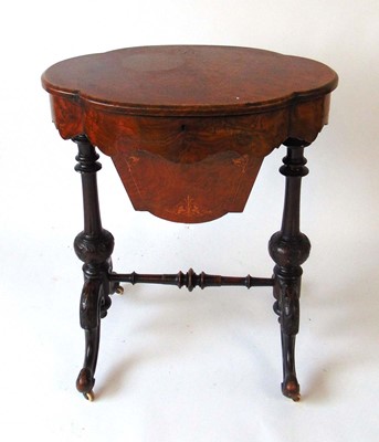 Lot 20 - A Victorian walnut work table, the well...