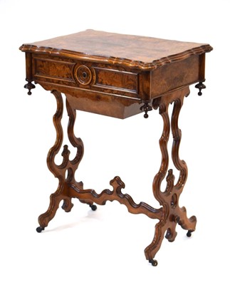 Lot 13 - A Victorian figured walnut sewing table, the...