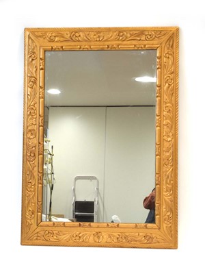 Lot 17 - A giltwood wall mirror, the rectangular plate...