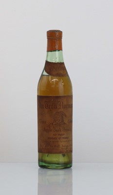 Lot 7 - An old half size bottle of Un Trou Normand...