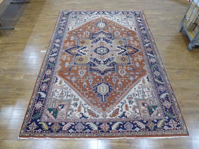 Lot 6 - An Iranian wool carpet with a central...