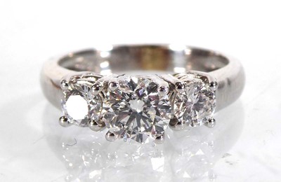 Lot 818 - An 18ct white gold ring set three graduated...