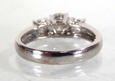 Lot 818 - An 18ct white gold ring set three graduated...