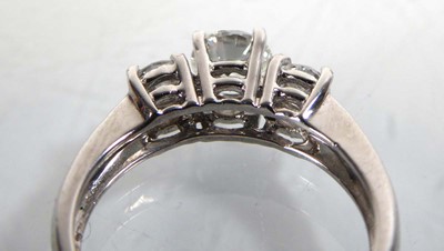 Lot 818 - An 18ct white gold ring set three graduated...