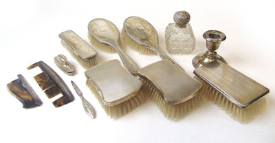 Lot 411 - A group of silver-backed brushes and combs...