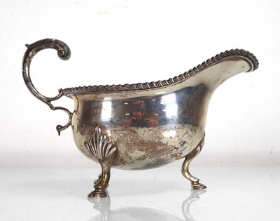 Lot 409 - A silver cream jug with leaf capped c-scroll...