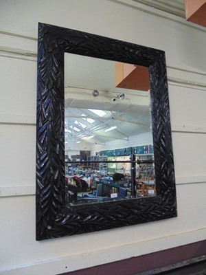 Lot 134 - A large bevel glass mirror with black painted...