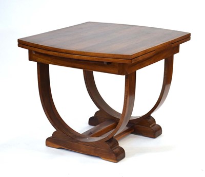 Lot 8 - An Art Deco walnut extending dining table on...