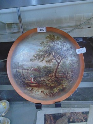 Lot 316 - A terracotta plate with hand painted farmyard...