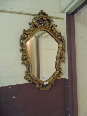 Lot 16 - An ornate gilt framed wall mirror