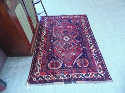 Lot 23 - A red ground eastern rug