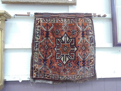 Lot 38 - An eastern prayer rug on a metal wall mounted rod