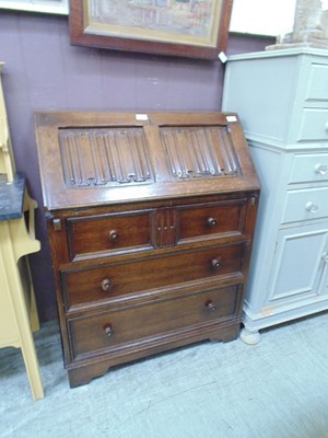 Lot 55 - A mid-20th century oak fall front bureau...