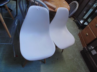 Lot 115 - A pair of cream Eames style chairs