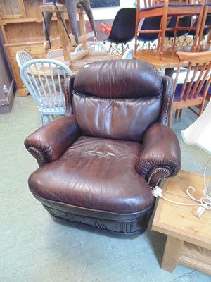 Lot 118 - A brown leather effect easy chair with metal...