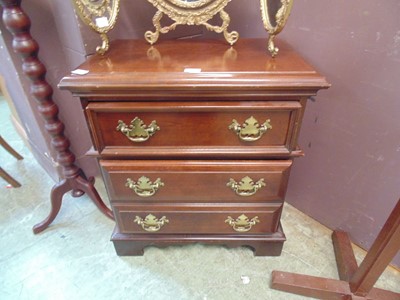 Lot 122 - A reproduction mahogany effect three drawer chest