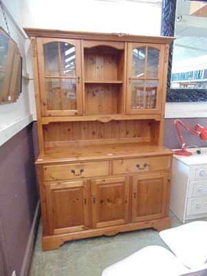 Lot 133 - A modern pine dresser having a two door glazed...