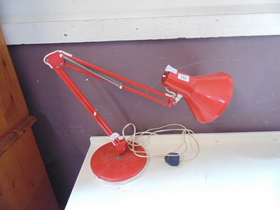 Lot 135 - A red metal Angle Poise style lamp