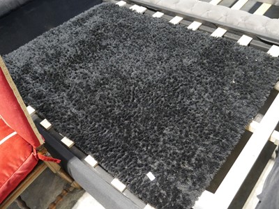 Lot 1132 - Black fluffy rug (120x170cm)