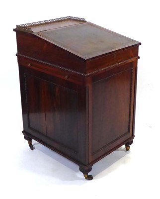 Lot 15 - A Regency rosewood davenport with sliding...