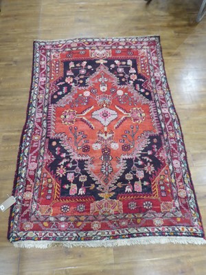 Lot 19 - An Iranian wool carpet with central medallion...