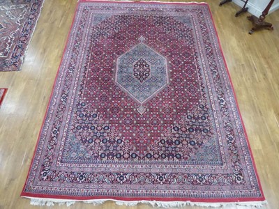 Lot 20 - An Iranian wool carpet with pale blue central...