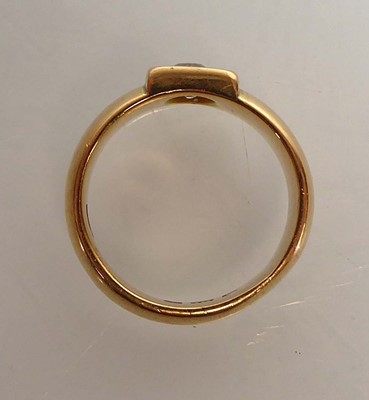 Lot An 18ct yellow gold ring set brilliant cut...