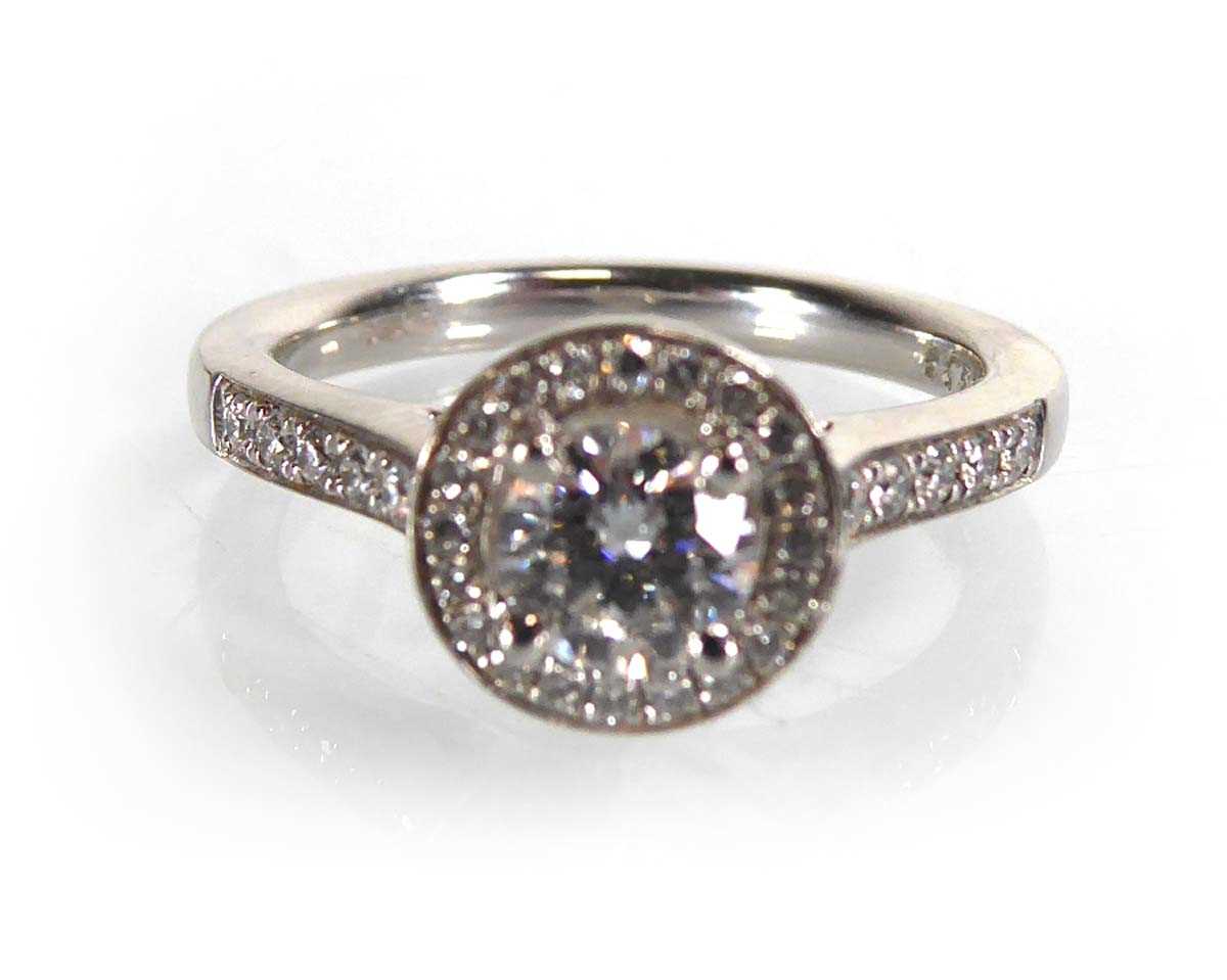 Lot A platinum halo ring set brilliant cut diamond...