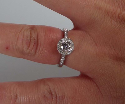 Lot A platinum halo ring set brilliant cut diamond...