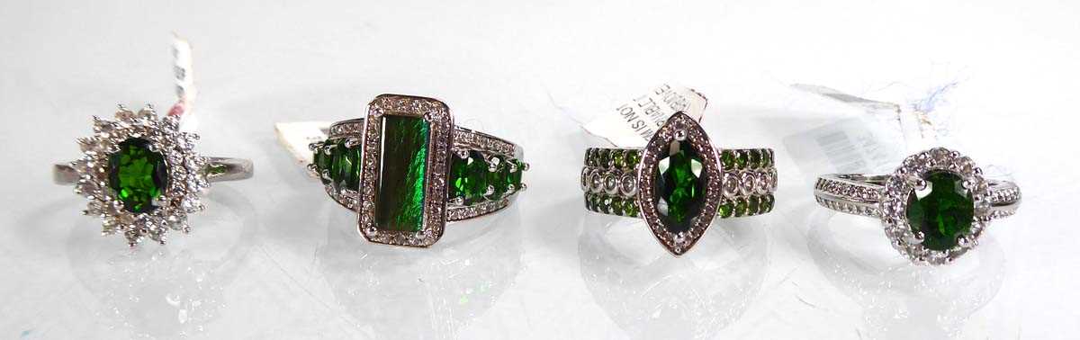 Lot 805 - Four silver dress rings set green and clear...