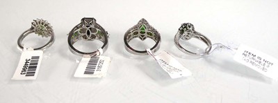 Lot 805 - Four silver dress rings set green and clear...