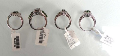 Lot 805 - Four silver dress rings set green and clear...