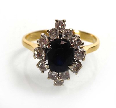 Lot An 18ct yellow gold cluster ring set oval...