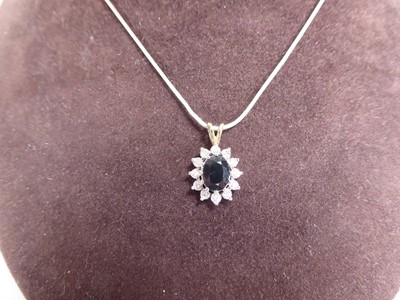 Lot A silver snakelink necklace suspending a 9ct...