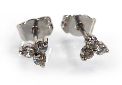 Lot A pair of 18ct white gold ear studs, each set...