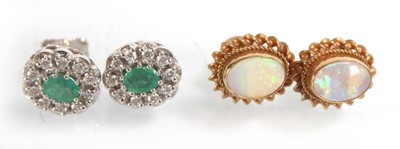 Lot A pair of 9ct yellow gold ear studs set opal...