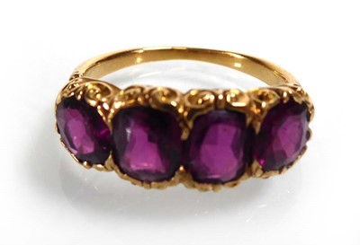 Lot A yellow metal ring set four amethyst within...