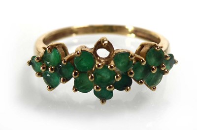 Lot A 9ct yellow gold ring set small emeralds in...