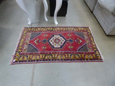 Lot 5320 - Woollen mat with central medallion and red...