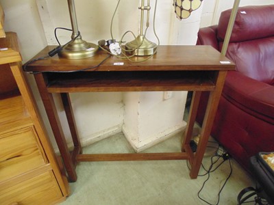 Lot 28 - A modern hardwood side table with open storage