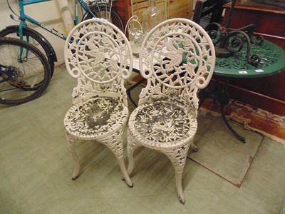 Lot 39 - A pair of white painted cast garden chairs