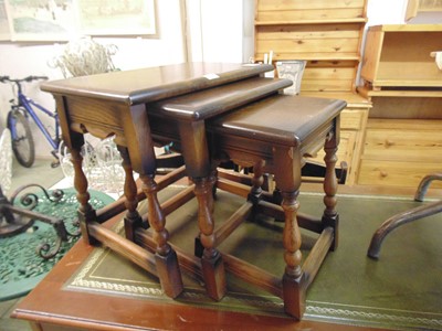 Lot 42 - A nest of three dark Ercol occasional tables